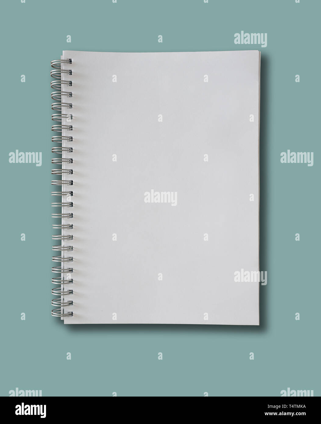 spiral-bound blank page notepad on blue background Stock Photo