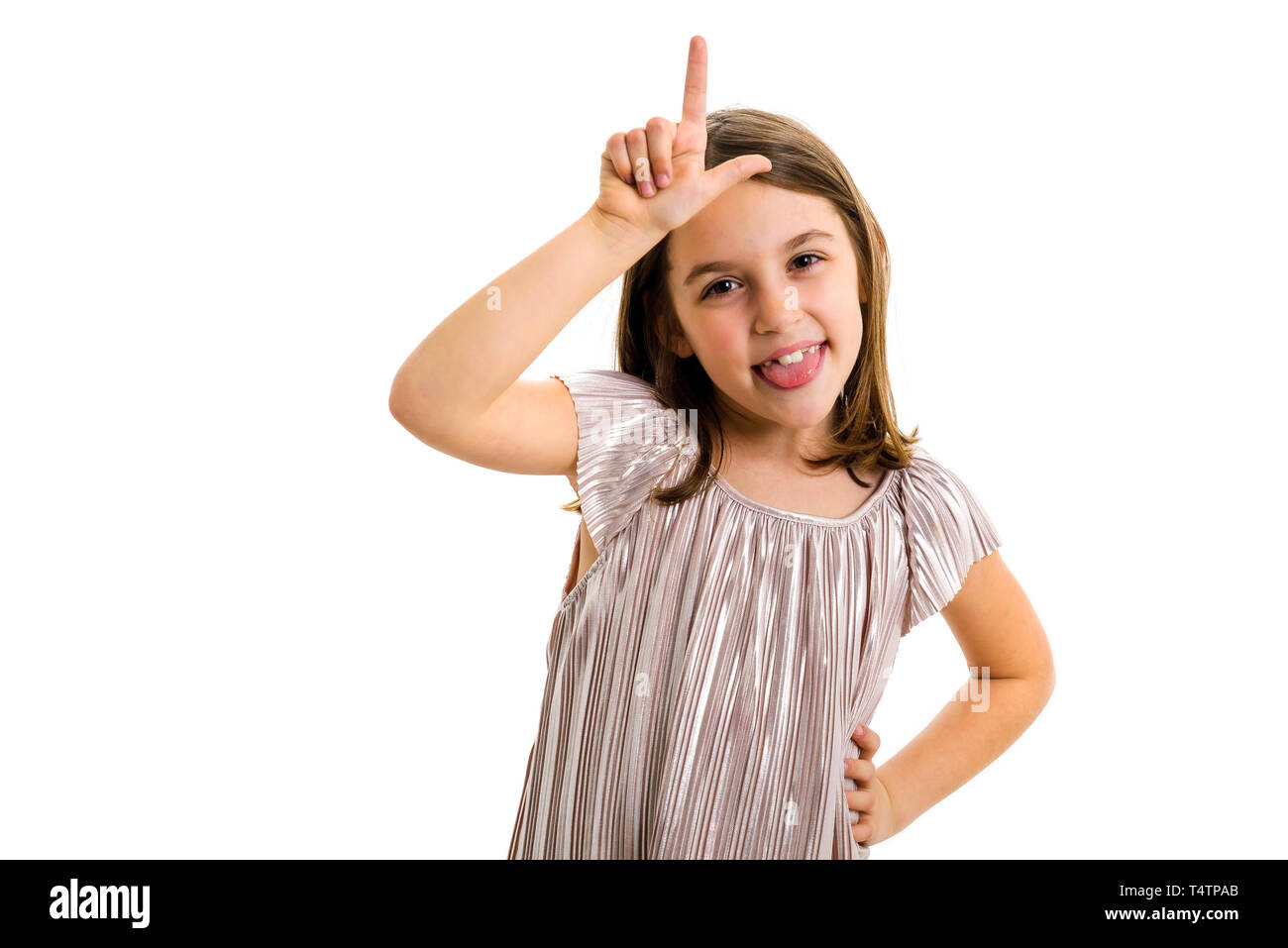 Portrait of happy girl making loser hand gesture at camera. Portrait of a cheerful cute little child girl looking at the camera, smiling showing L sig Stock Photo