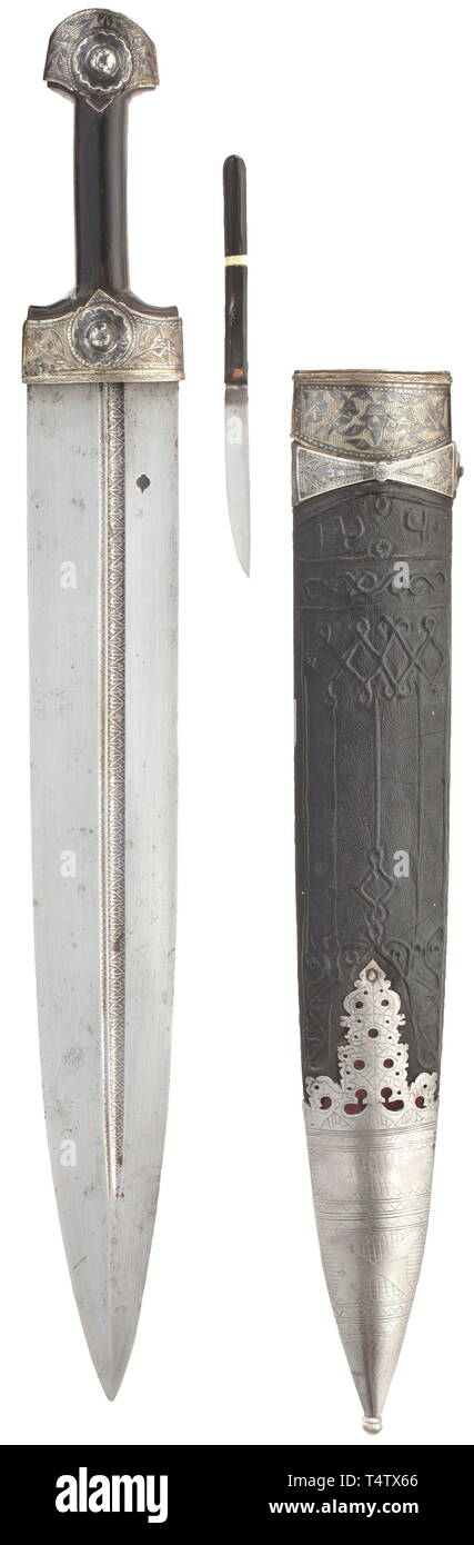A Caucasian Hetmann kinjal, dated 1844. Double-edged broad blade, the fullers on either side set at different heights and etched with a geometrical pattern. The base struck on both sides with an onion-shaped smith's mark. Constricted horn grip with nielloed silver mounts. The obverse of the shagreen leather-covered wood scabbard decorated with cord and bearing the date '1260' (= 1844). En suite nielloed upper scabbard fitting made from silver, the chape emboosed with a geometrical pattern. The reverse with by-knife (of later date). Length 64 cm. , Additional-Rights-Clearance-Info-Not-Available Stock Photo