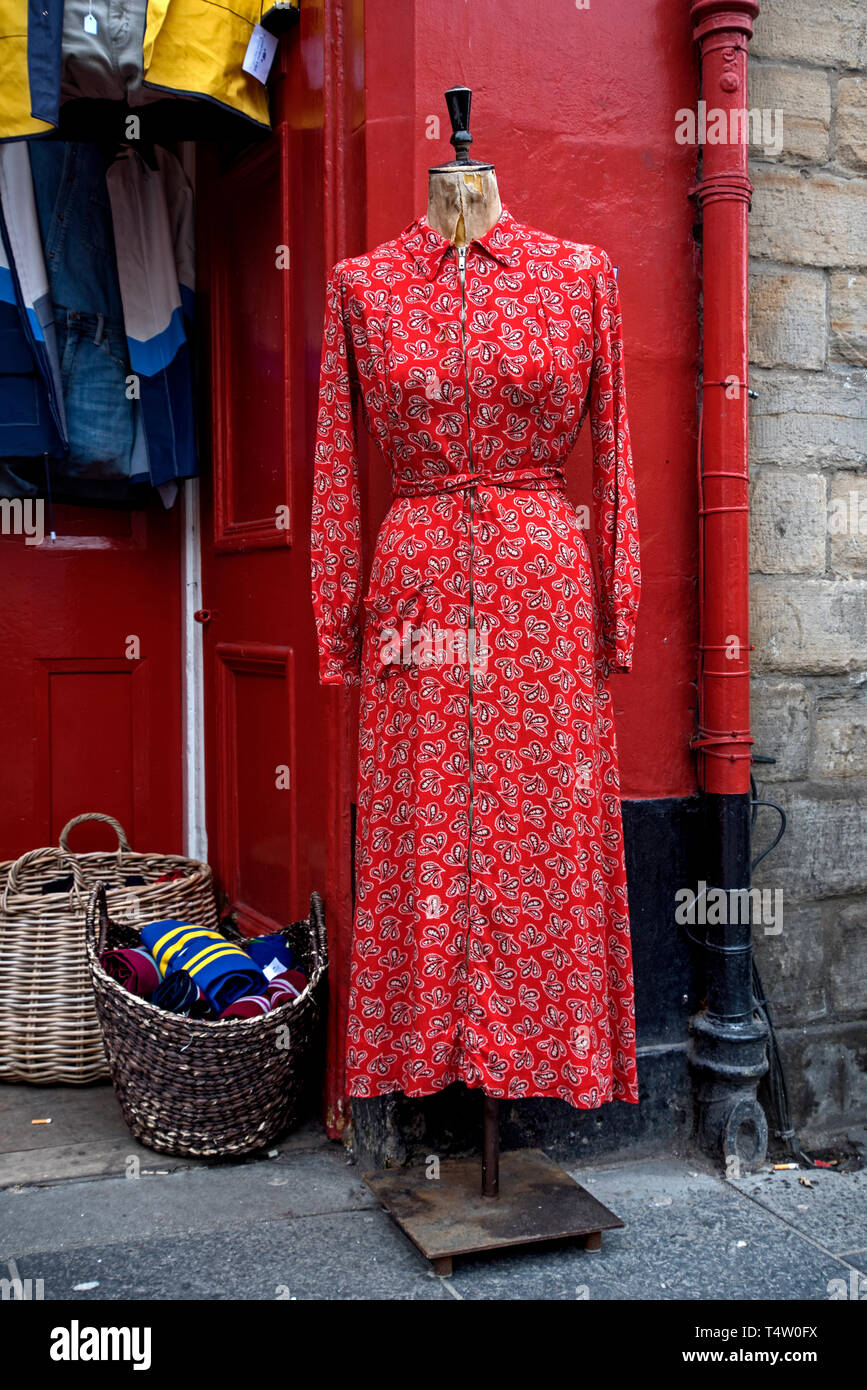 A vintage red dress on a tailor's dummy outside Armstrong's in the Grassmarket, Edinburgh. Stock Photo