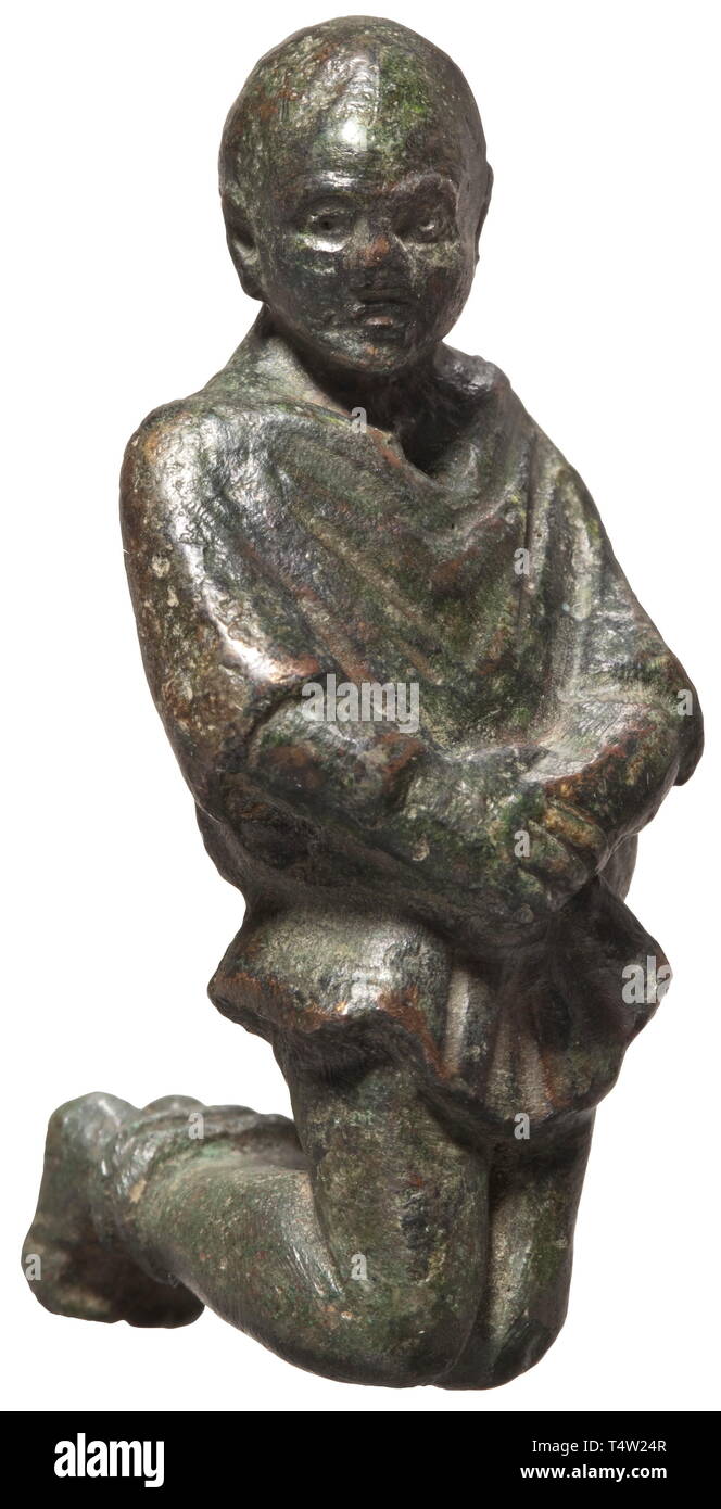 A Roman figure of a Germanic prisoner, 2nd/3rd century AD Bronze with dark green patina. Kneeling male figure with bound hands and feet and typical hairstyle. Height 6 cm. Provenance: South German private collection, 1970s and later. historic, historical, Roman Empire, ancient world, ancient times, ancient world, Additional-Rights-Clearance-Info-Not-Available Stock Photo