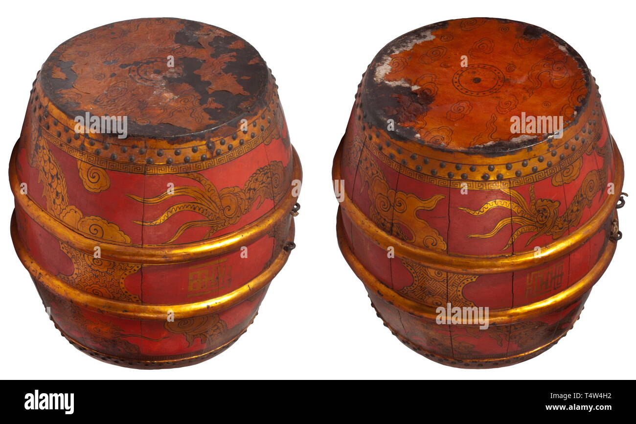 A pair of Chinese temple drums, 19th century The bodies of the drums built by staves, each with two rings and iron suspension loops. Rendered in colour with cloud dragons and golden characters on a red background. The drumheads rendered in gold lacquer. Including the matching protective brass covers. Height 53 cm each. historic, historical, China, Chinese, 19th century, Additional-Rights-Clearance-Info-Not-Available Stock Photo