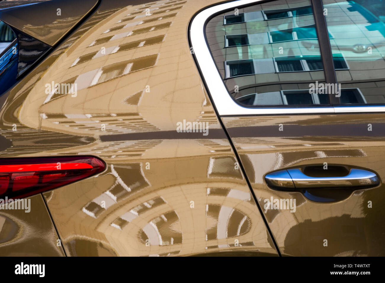 A high-rise apartment block reflected in a car window in Berlin, Germany. Stock Photo