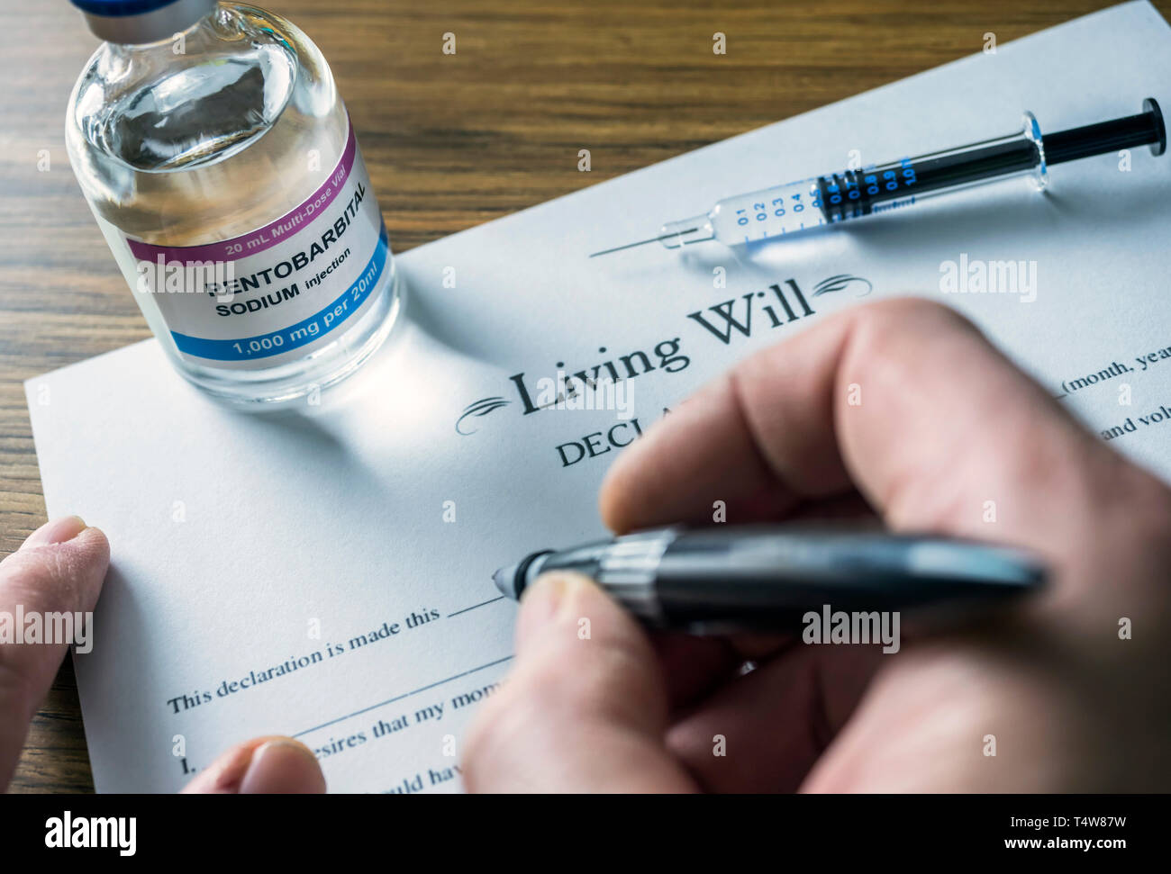 Living will declaration form Next to a vial of pentobarbital sodium to proceed to euthanasia, conceptual image Stock Photo