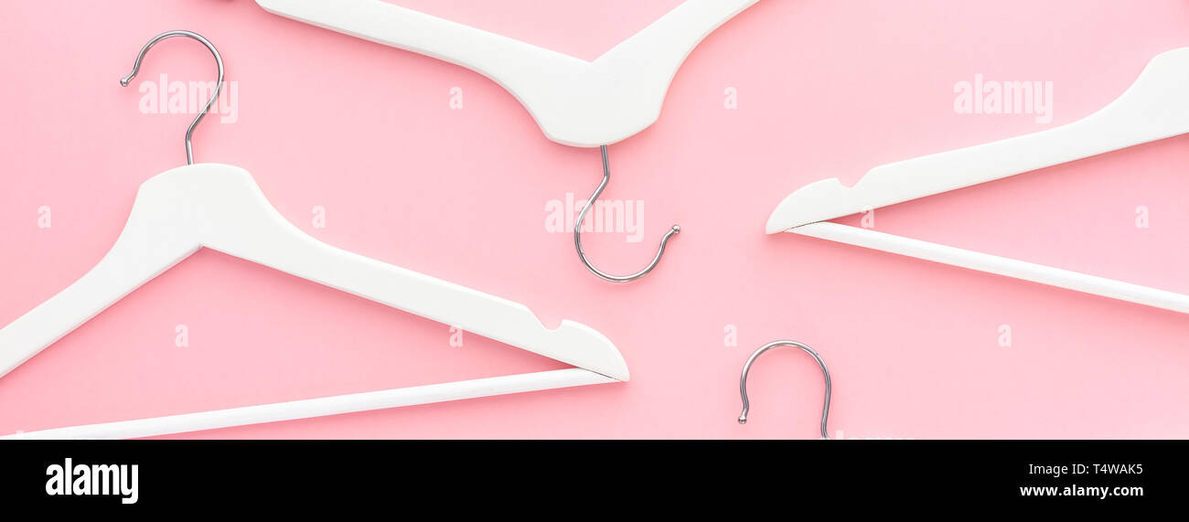Creative top view flat lay white wooden hangers pastel millennial pink ...
