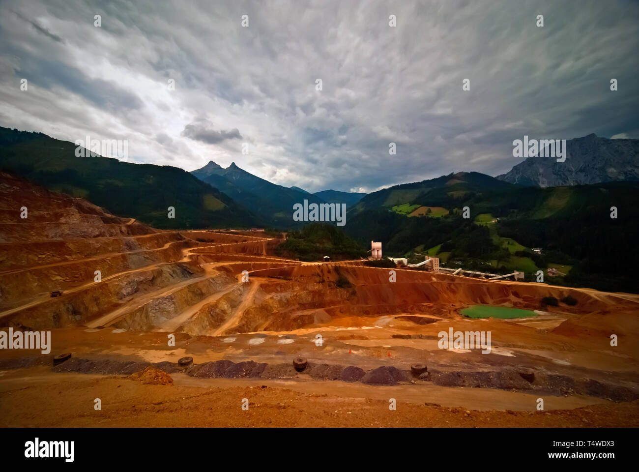 The Eisenerz open-pit mine and the haul trucks Stock Photo