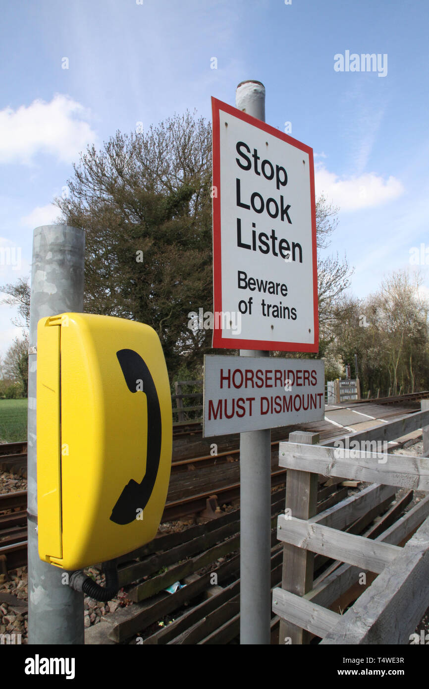 A 'Stop, Look, Listen' sign with an phone at the side of pedestrian crossing of the Hull to Scarborough railway line at Spark Mill Lane Beverley Stock Photo