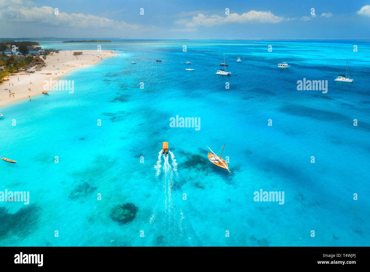 Aerial view of the yachts, fishing boats in clear blue water at sunny ...