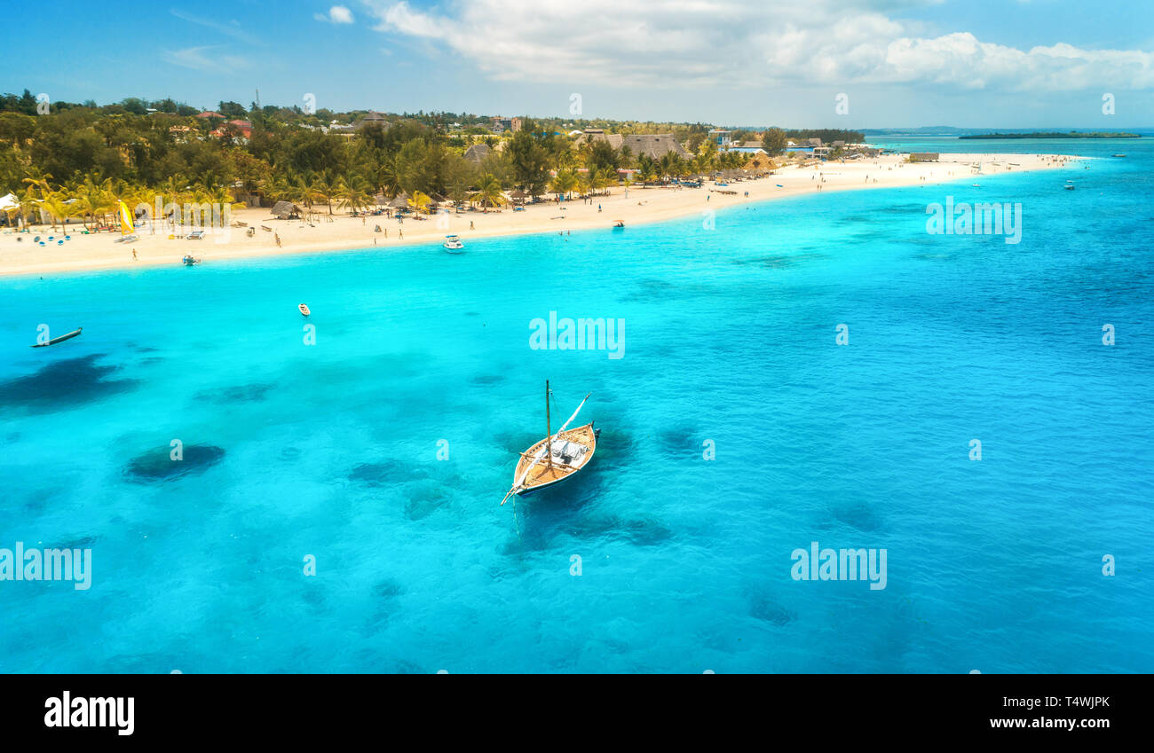Aerial view of the fishing boat in clear blue water at sunny day in ...