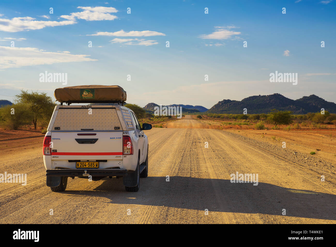 4x4 rental car equipped with a roof tent driving through Damaraland in Namibia Stock Photo