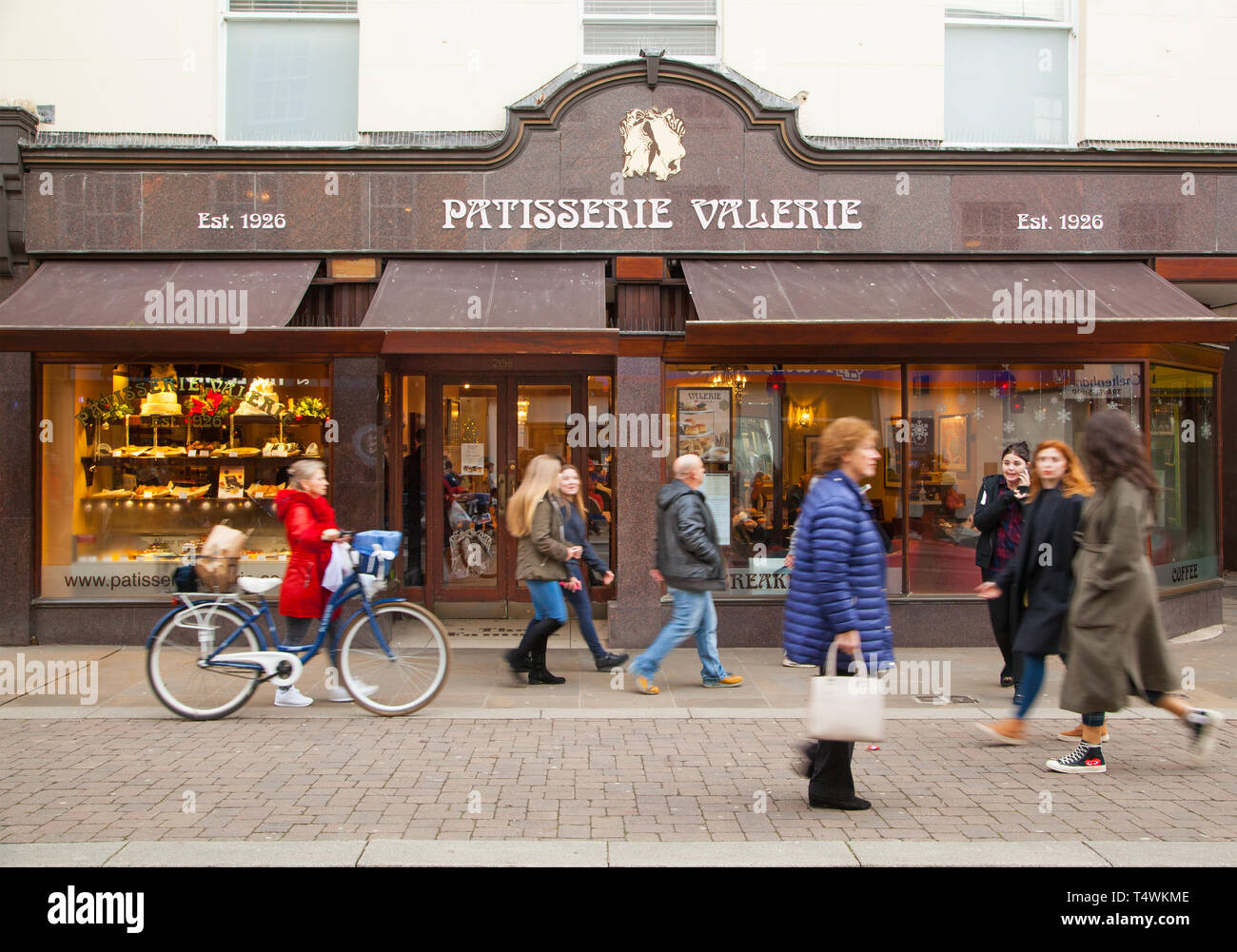 People walking past high street cafe coffee shop confectioner Patisserie Valerie Stock Photo