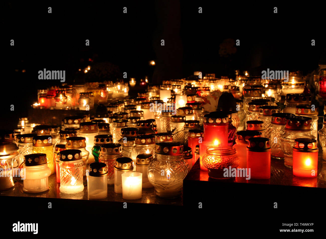 Bunch of cemetery candles in a dark Stock Photo