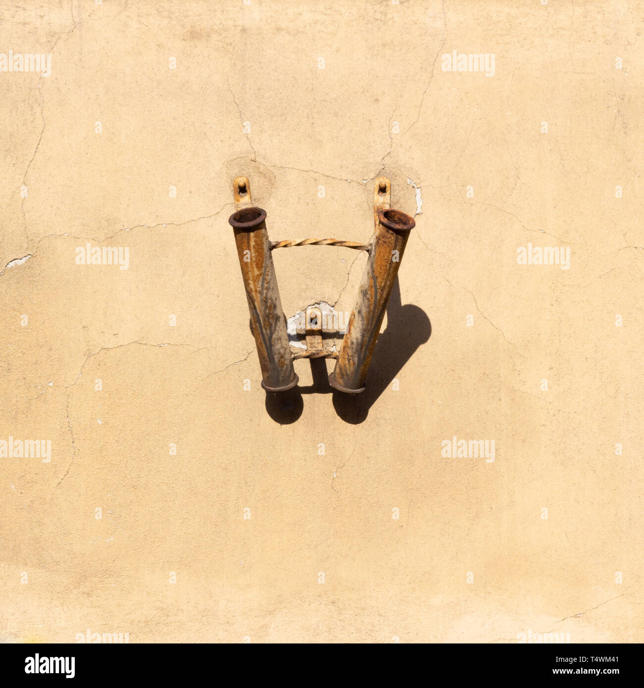 Old rusty flag holder on wall Stock Photo