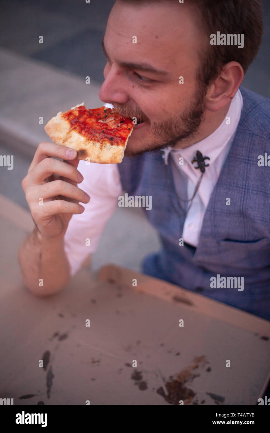 One Young Businessman 29 Years Old Eating A Slice Of Pizza Side View Stock Photo Alamy
