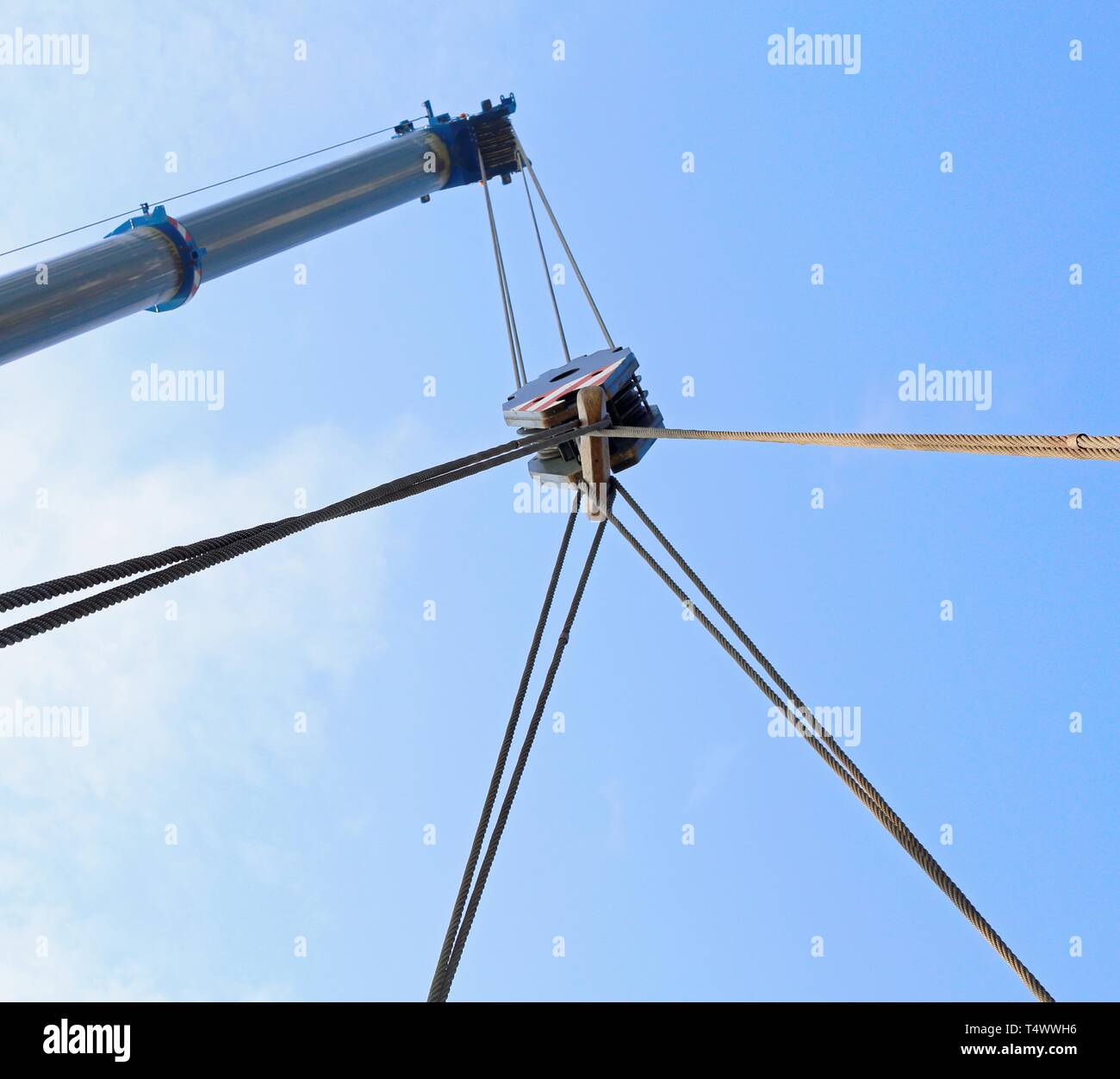 hydraulic arm of a powerful crane for lifting heavy loads at an industrial site Stock Photo