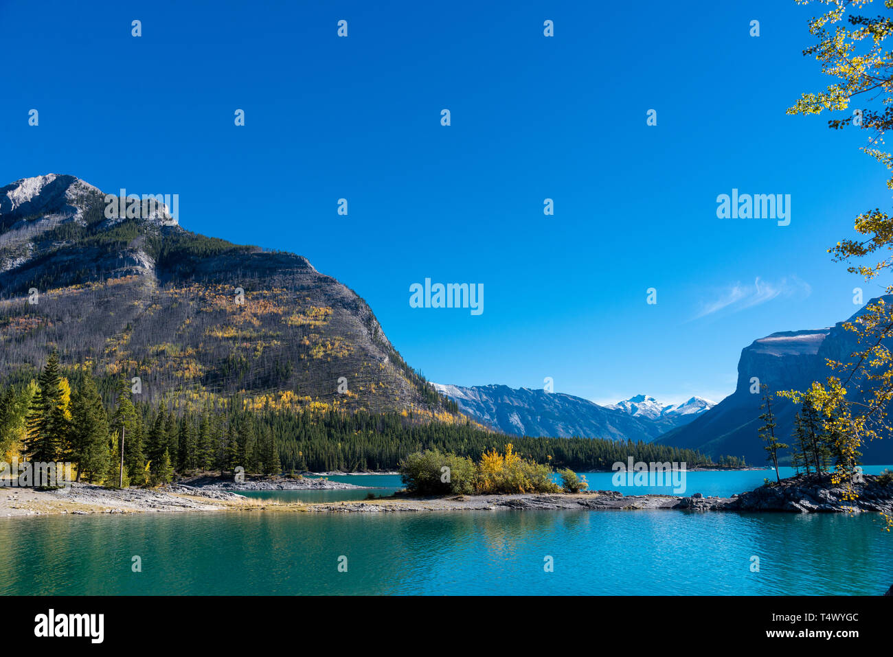 BANFF NATIONAL PARK, CANADA / SEPTEMBER 13, 2016:  A view across placid Lake Minnewanka in Banff National Park on a clear September morning. Stock Photo