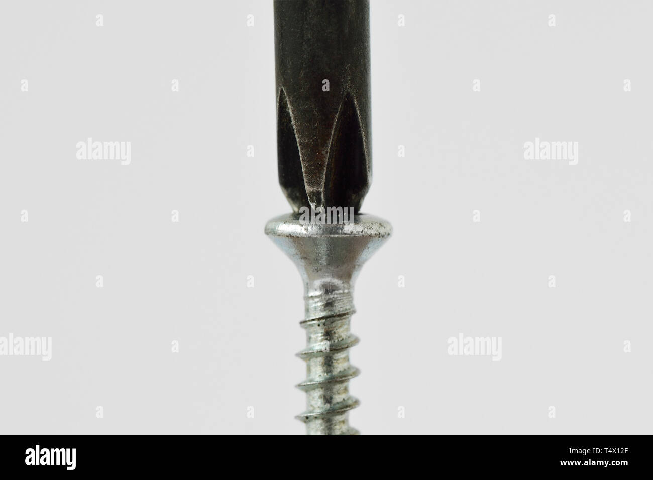 Screwdriver on screw - Concept of problem solving; finding a solution to a problem Stock Photo