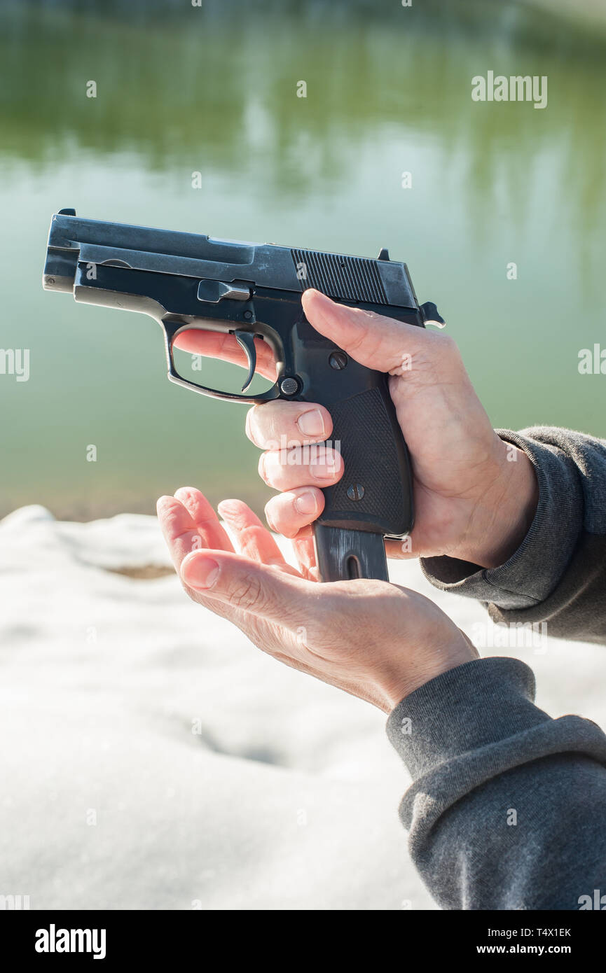Close-up detail view of a cartridge bullet clip gun reloading. Load and ...