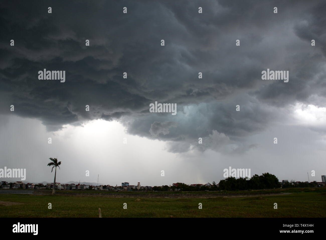 Dark storm clouds over Ha Tinh, Vietnam, as a lightning storm approaches Stock Photo