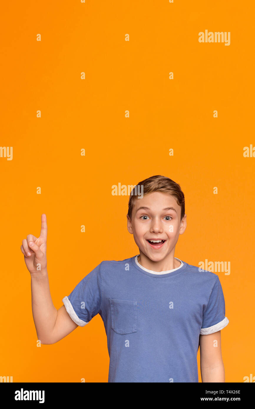 Excited teenage boy have great idea, pointing finger up Stock Photo
