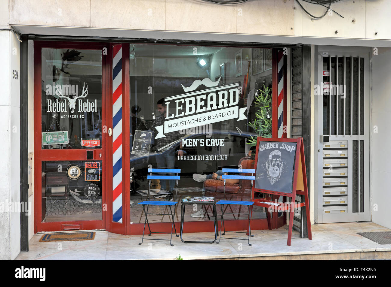 Barber Shop LeBeard outside view of hipster storefront and window graphics signs on Rua de Cedofeita in Porto Portugal Europe  KATHY DEWITT Stock Photo