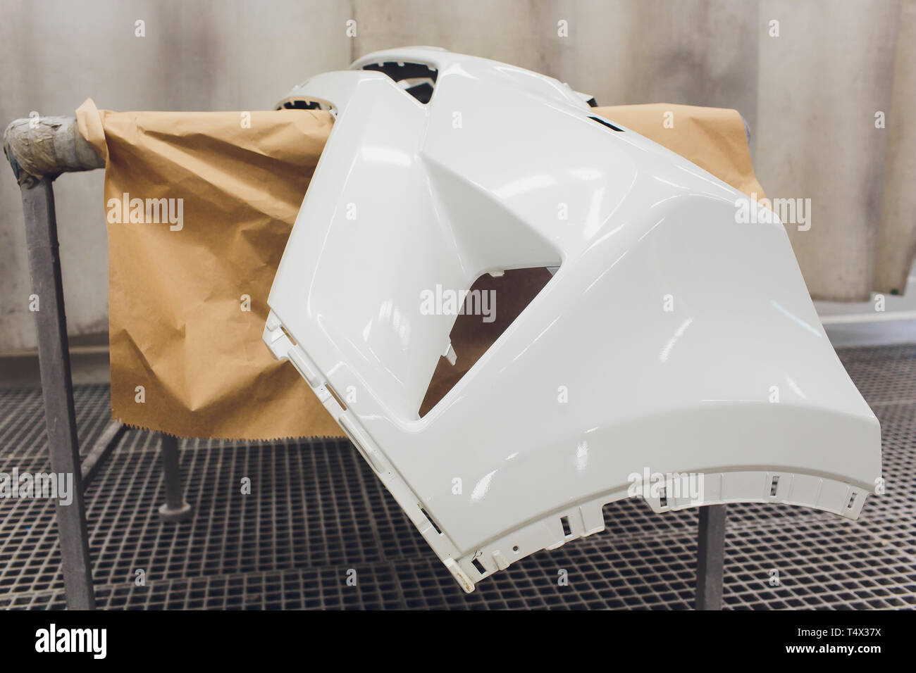 Repair of the rear bumper of a white car after an accident with the