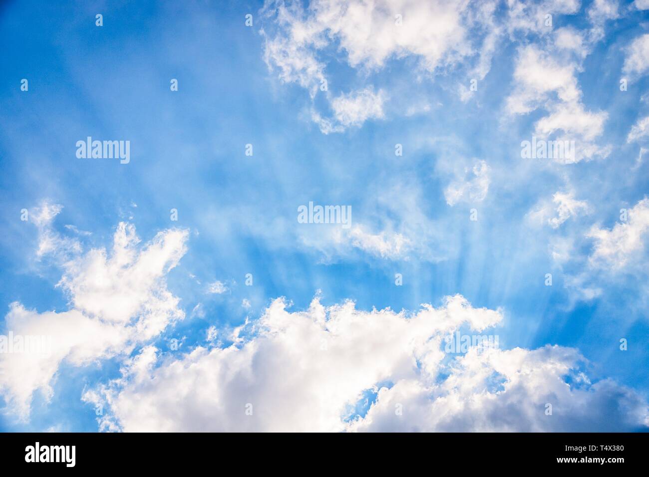 Amazing blue sky with fluffy white clouds and sun rays. Beam of light ...