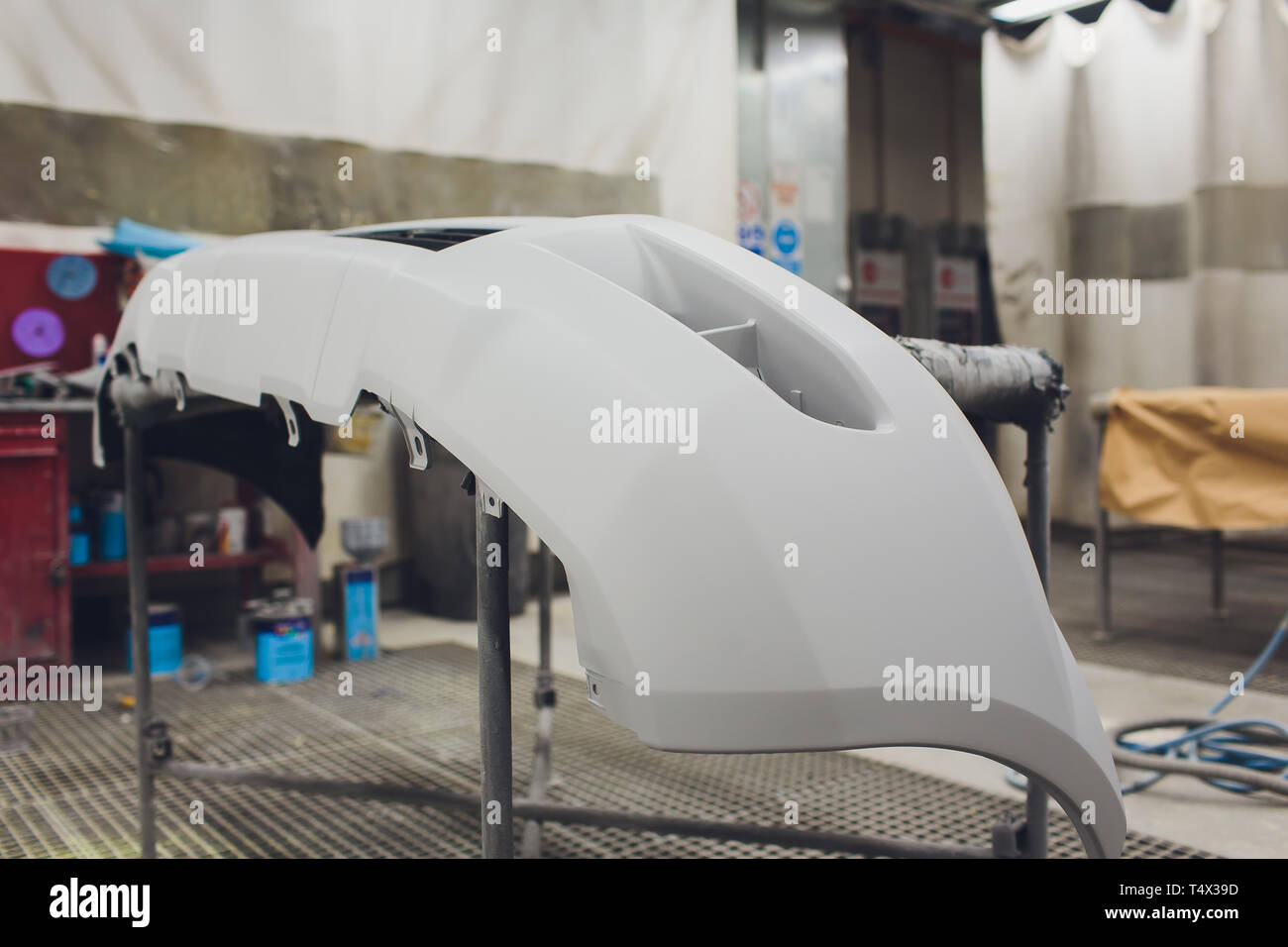 Repair of the rear bumper of a white car after an accident with the