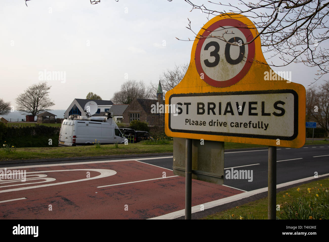 Sign for St Briavels, Gloucestershire, UK 18th April 2019, with BBC satellite truck in the background reporting acid attack story centred on village Stock Photo