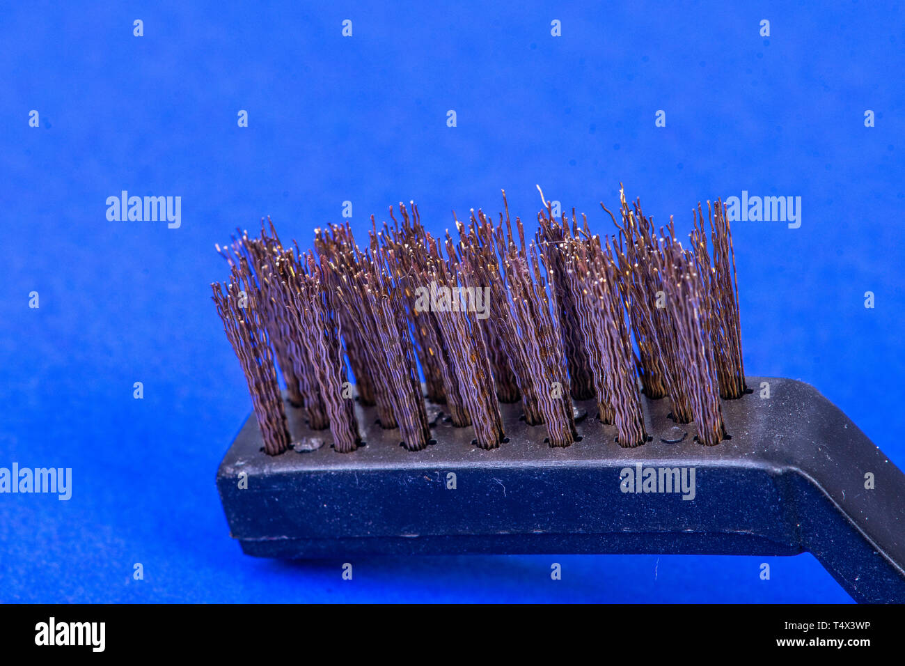 Steel brush on blue background Stock Photo