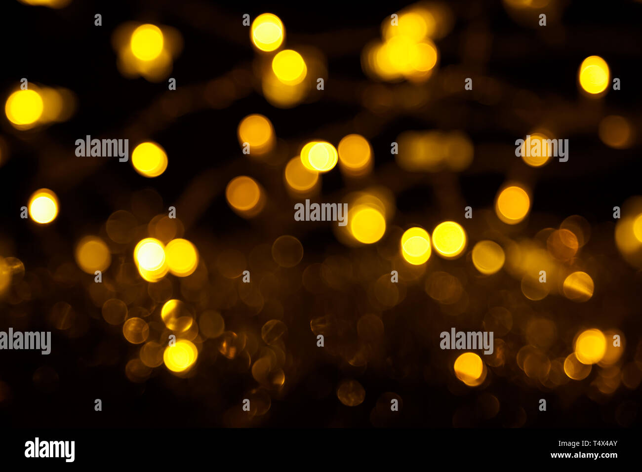 Abstract gold bokeh on black background. Defocused yellow lights, abstract  texture Stock Photo - Alamy