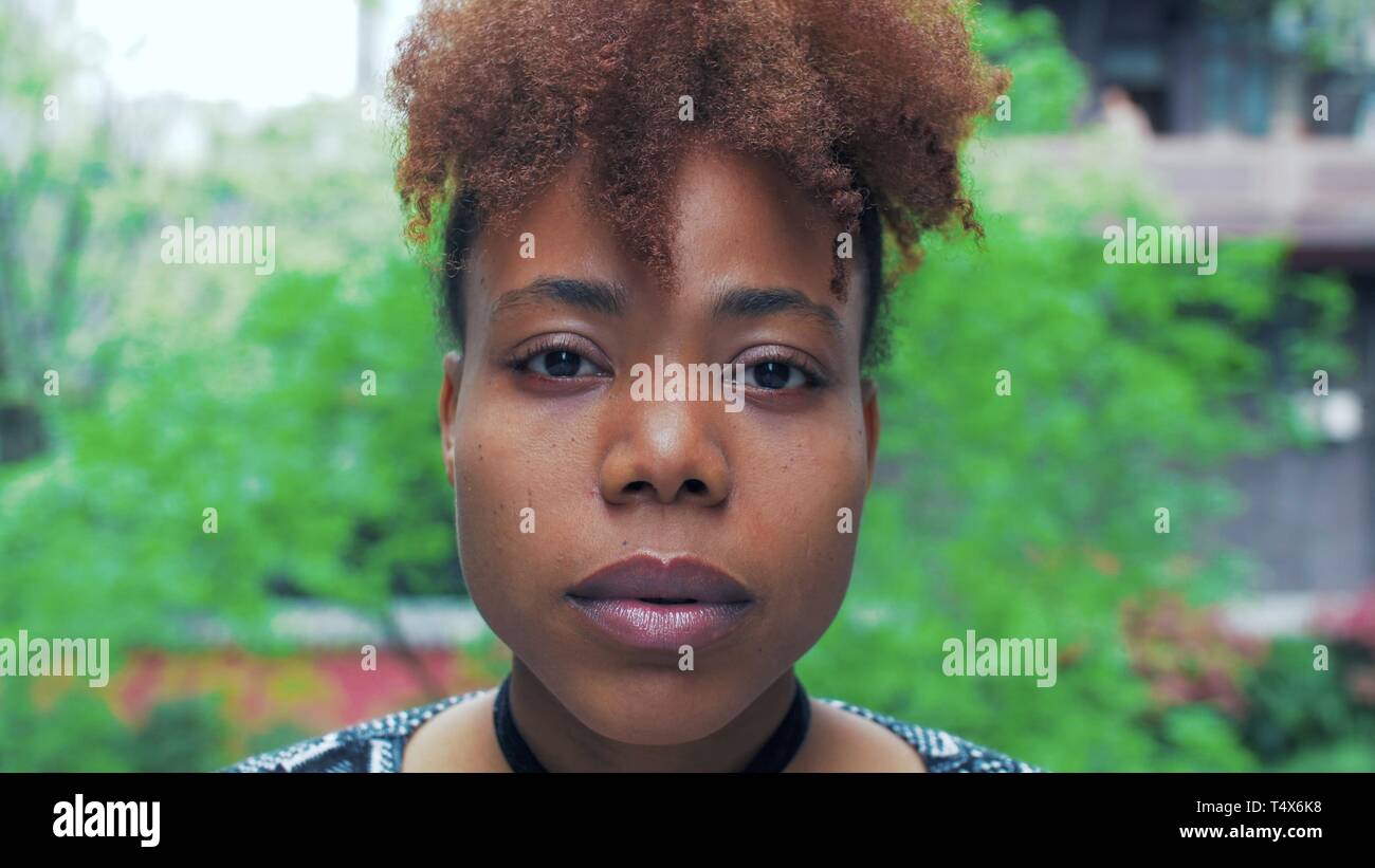 young black African young woman looking at camera with blank face no  emotion, real people portrait Stock Photo - Alamy