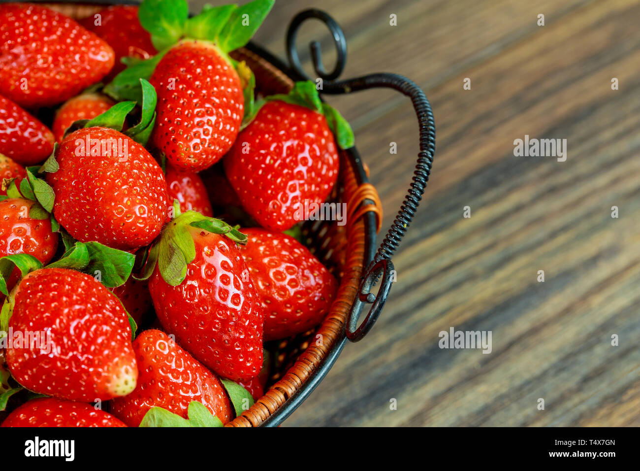 Fresh ripe strawberries in a basket on rustic wooden background Stock ...