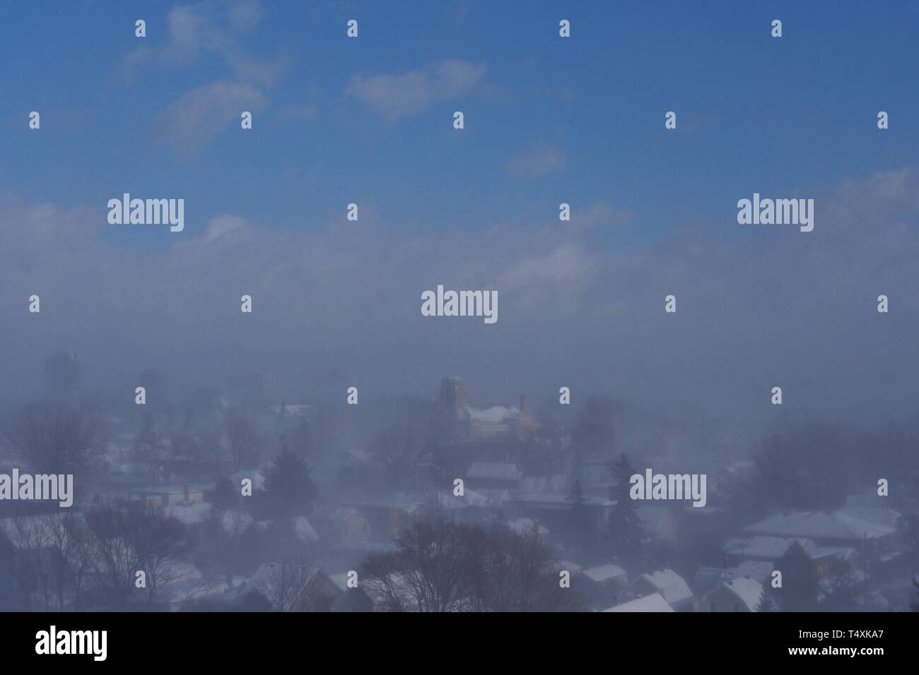 Despite a clear blue sky, a snow squall blankets downtown Ottawa during ...