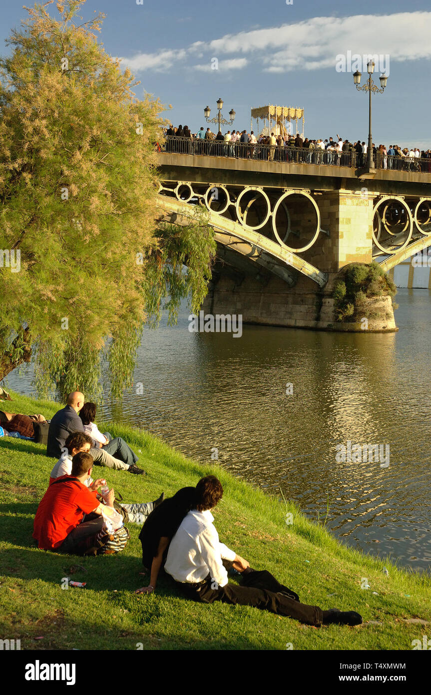 Holy Week. Procession of the brotherhood of El Cachorro, crossing the Triana bridge over the river Guadalquivir. Seville. Region of Andalusia. Spain.  Stock Photo