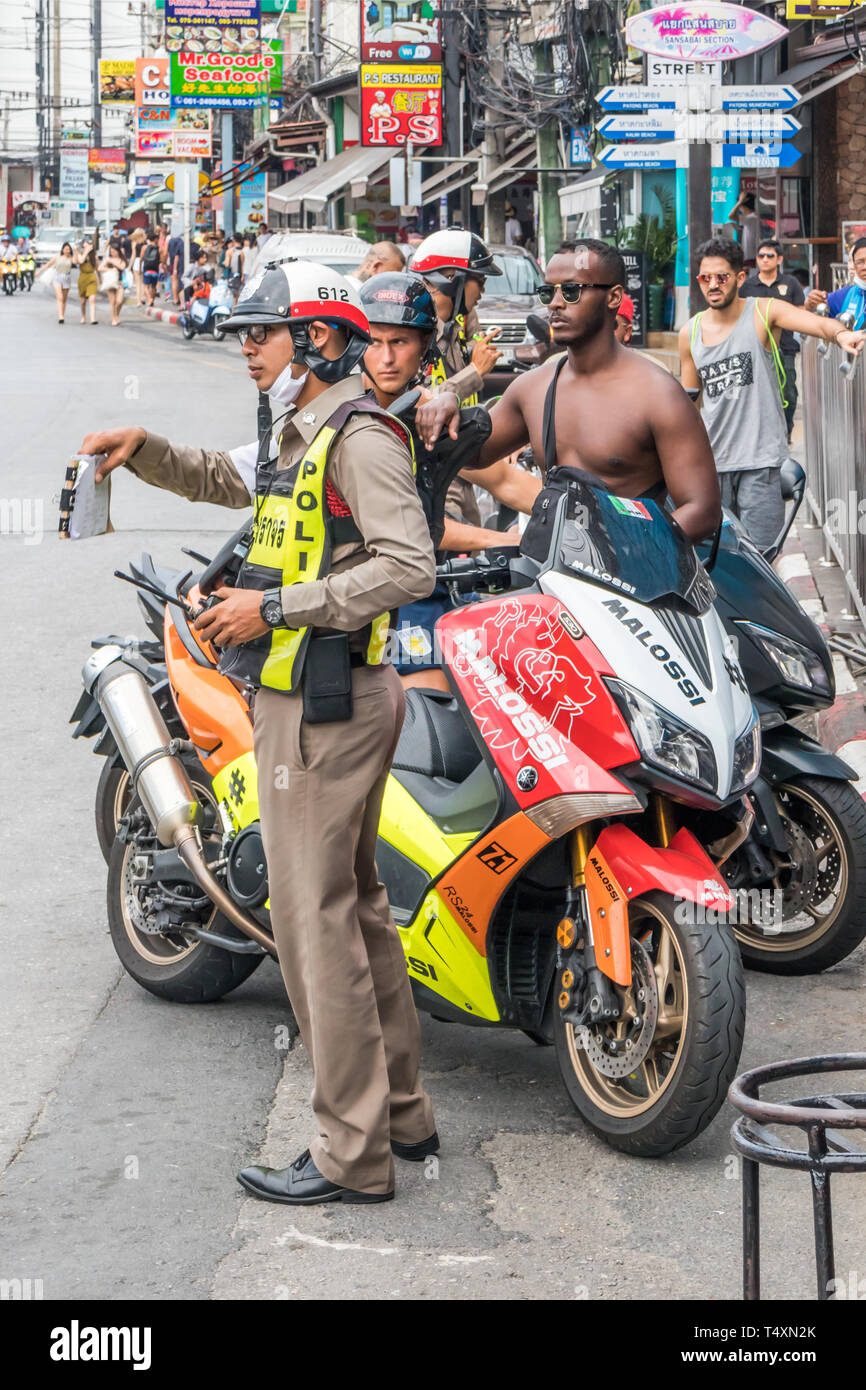 Phuket, Thailand 17th January 2019: Police checking tourists driving licenses in Patong Beach. Police often fine tourists for traffic offences. Stock Photo