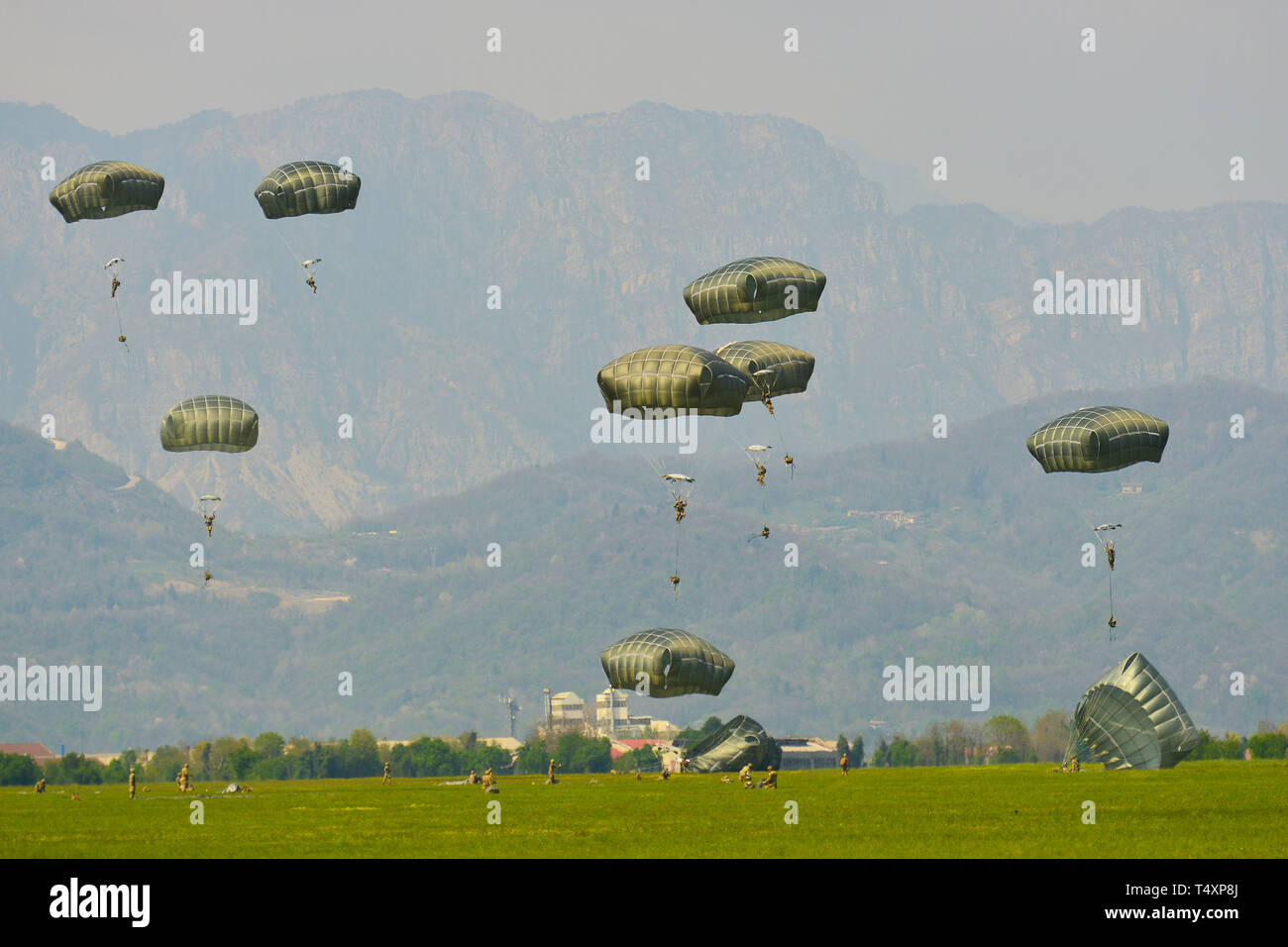 U.S. Army Paratroopers assigned to the 173rd Brigade Support Battalion, 173rd Airborne Brigade with British and Italian Army paratroopers, descend onto Juliet Drop Zone, Pordenone, Italy after exiting U.S. Air Force C-130 Hercules aircraft from the 86th Air Wing during airborne operation Apr. 16, 2019. The 173rd Airborne Brigade is the U.S. Army Contingency Response Force in Europe, capable of projecting ready forces anywhere in the U.S. European, Africa or Central Commands' areas of responsibility. (U.S. Army Photos by Davide Dalla Massara) Stock Photo
