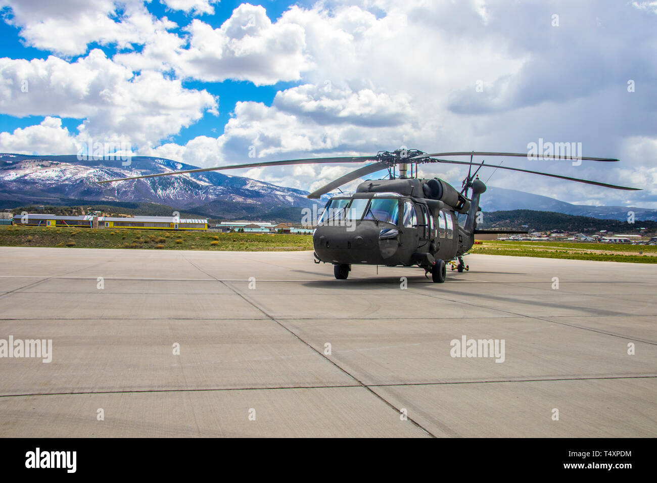 A UH-60 Blackhawk is towed back into storage at the High Altitude Army National Guard Aviation Training Site, Gypsum, Colo., April 17, 2019. 20 percent of HAATS students come from another branch of service or a foreign countries military. HAATS trains rotary wing aviators about power management in various airframes. (U.S. Army photo by Spc. Michael Hunnisett) Stock Photo
