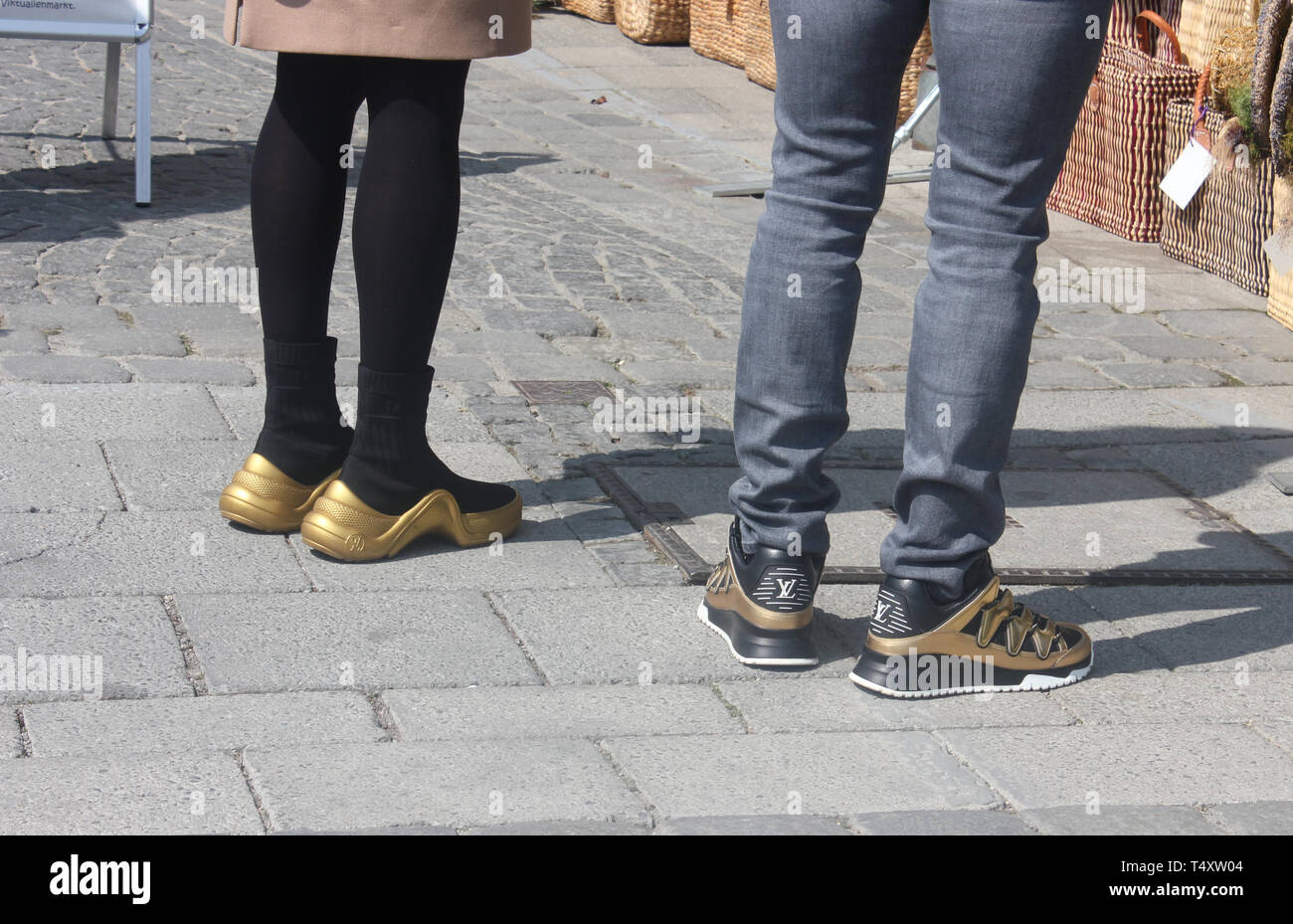 Partner look with golden designer shoes. Stock Photo