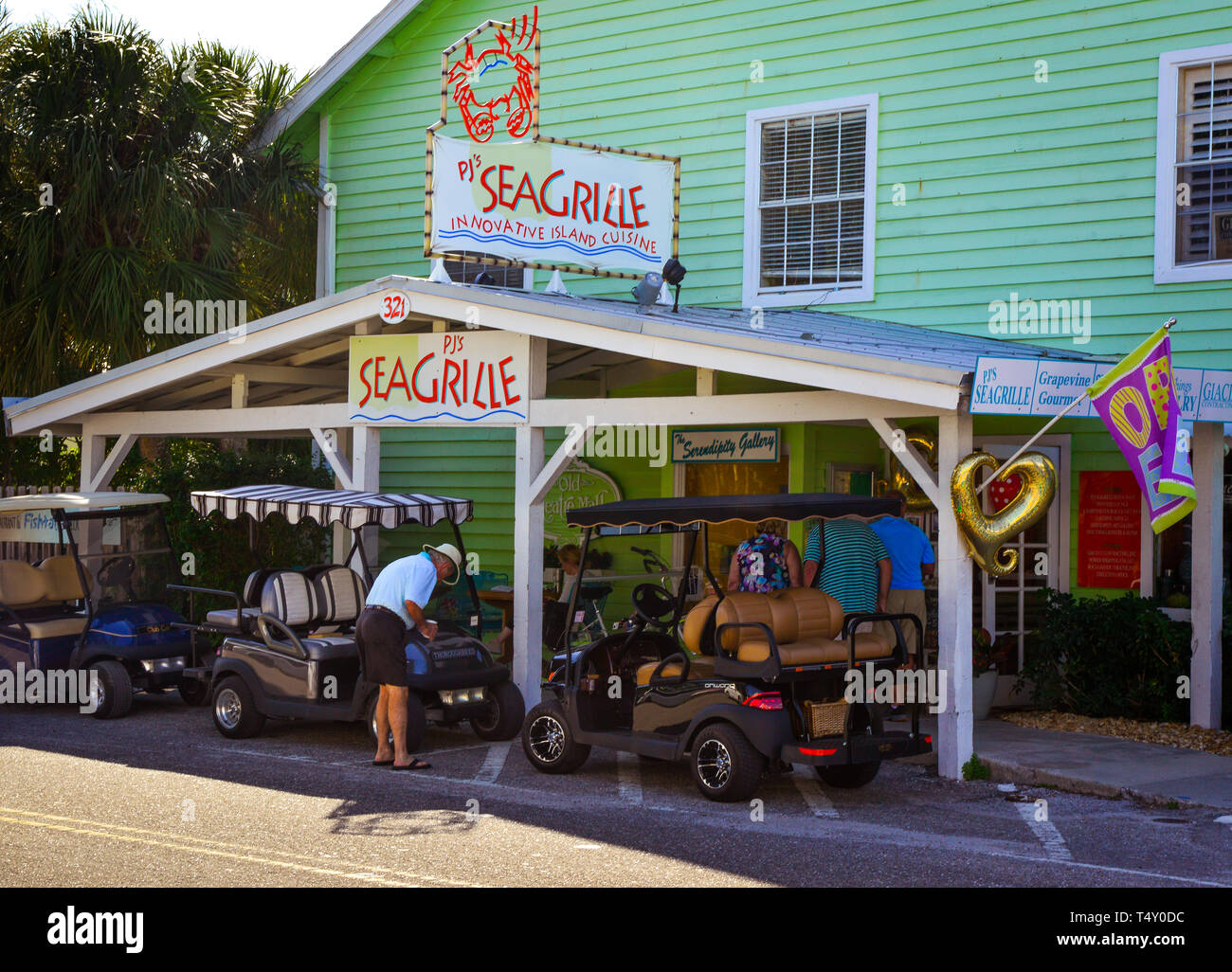 Golf Carts park in front of PJs Seagrille restaurant on Boca Grande, FL, on the Gasparilla Island in southwest Florida Stock Photo