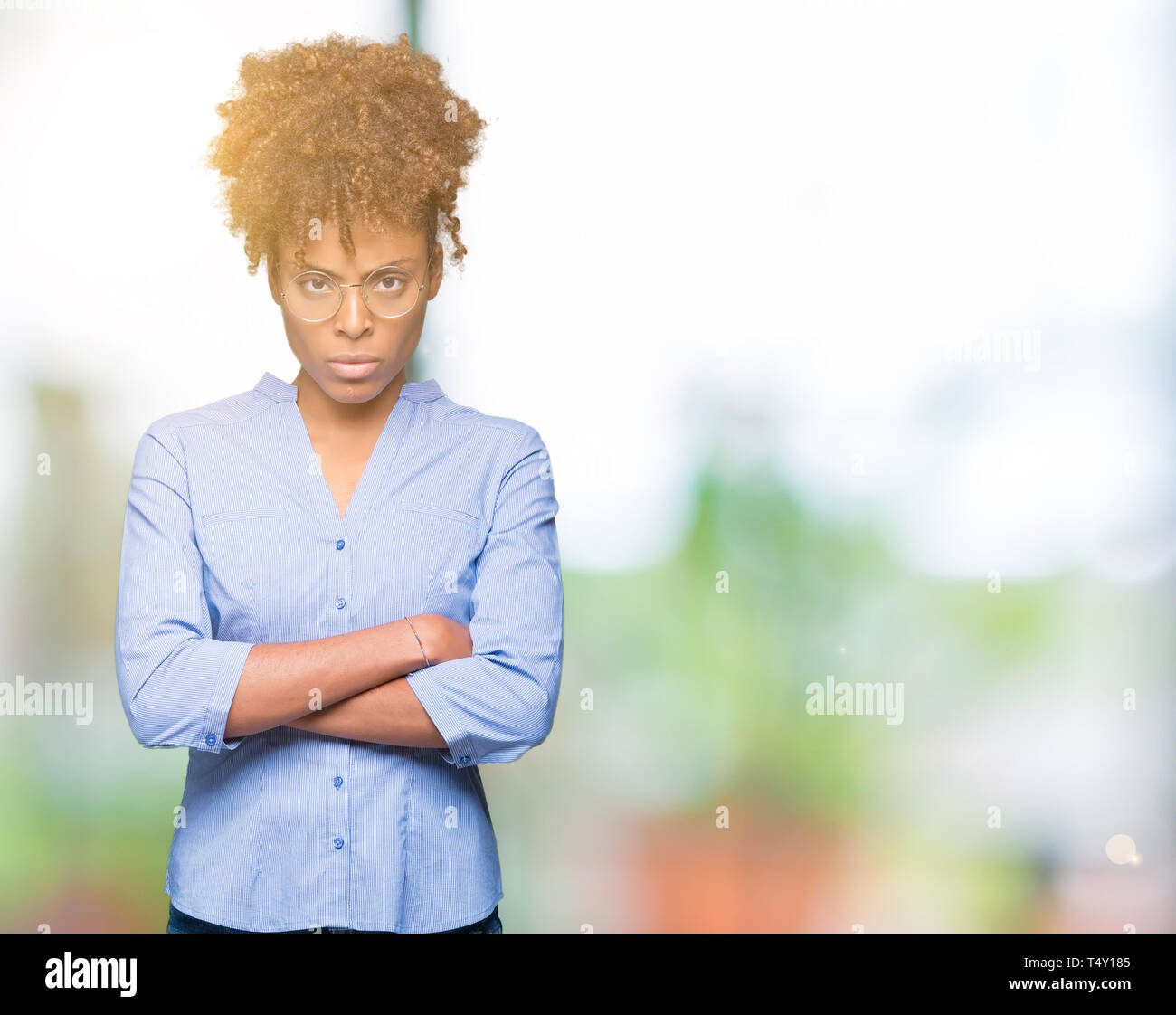 Beautiful young african american business woman over isolated background skeptic and nervous, disapproving expression on face with crossed arms. Negat Stock Photo