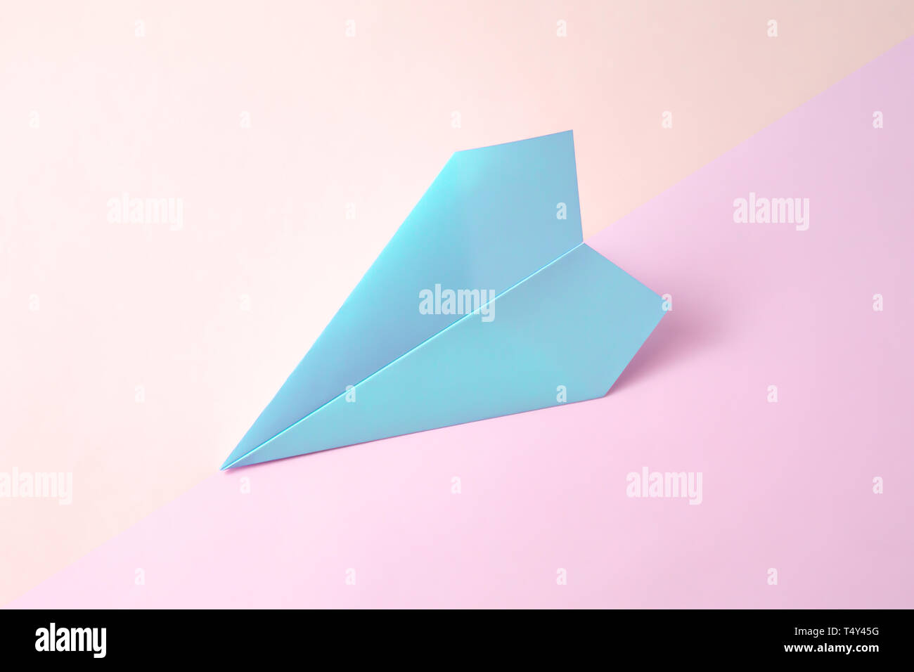 paper airplane on pastel background. Minimal flat lay school concept