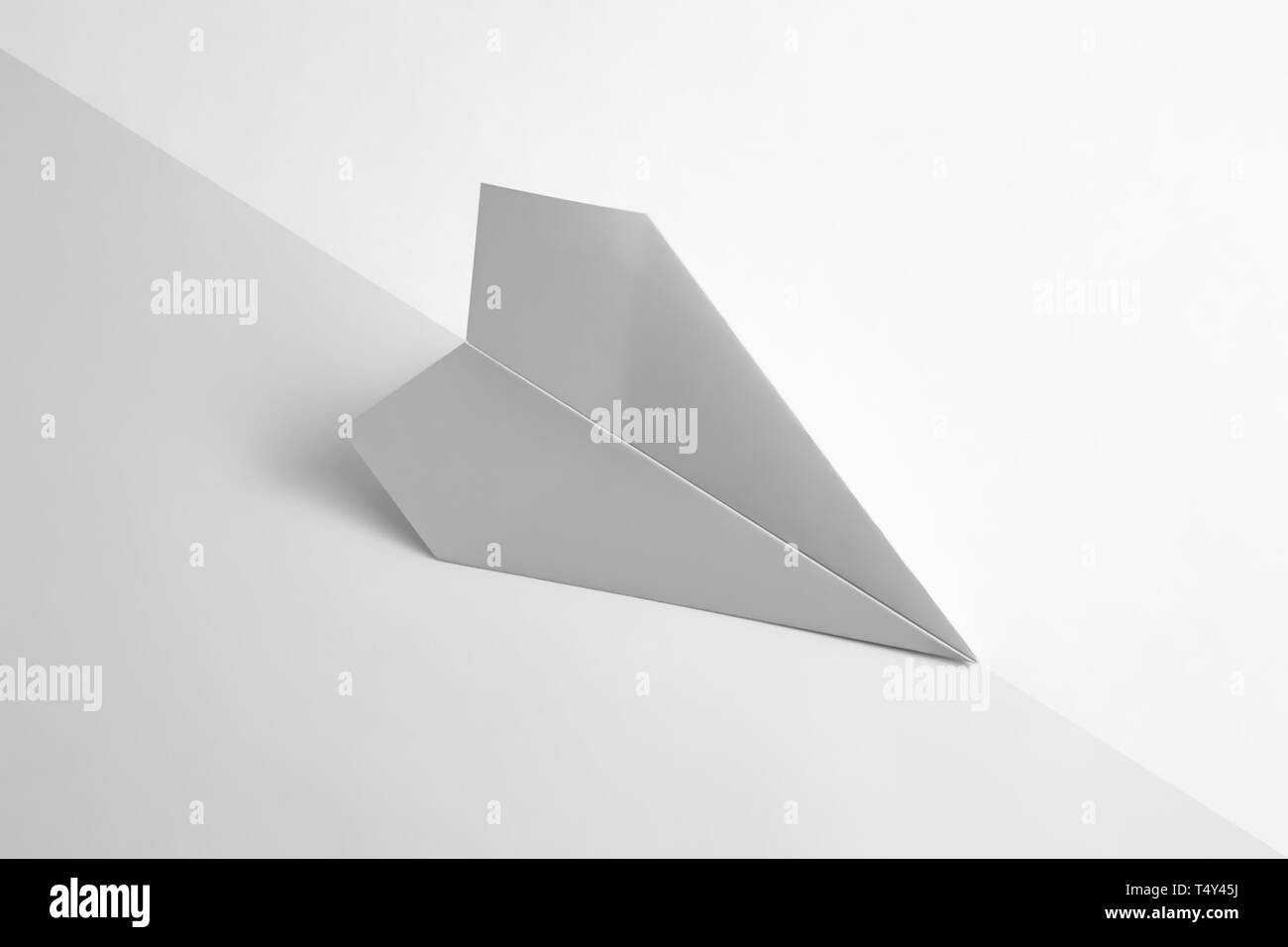 paper airplane on pastel background. Minimal flat lay school concept