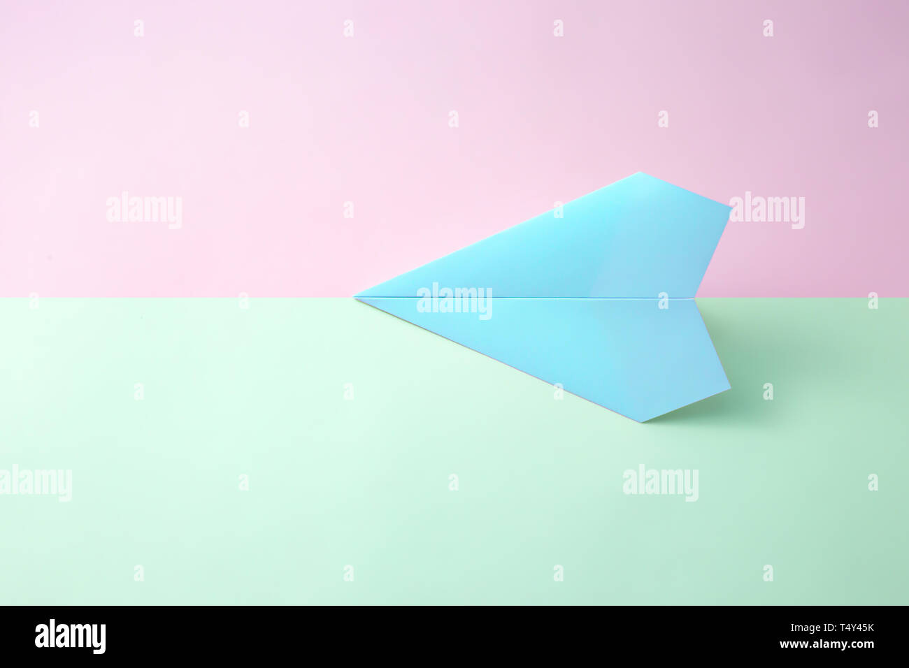 Paper Airplane On Pastel Background. Minimal Flat Lay School Concept 