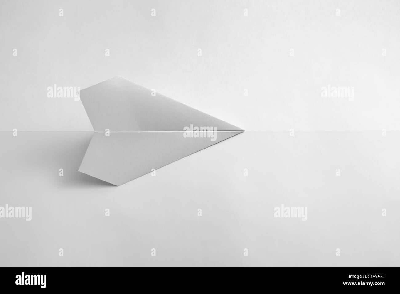 paper airplane on pastel background. Minimal flat lay school concept