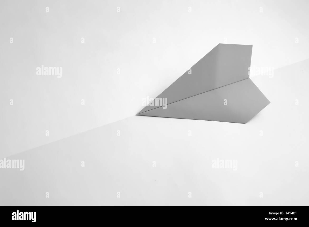 paper airplane on pastel background. Minimal flat lay school concept