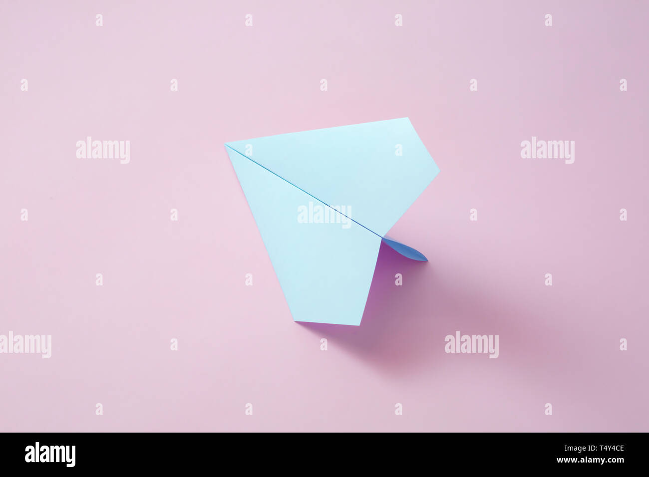 paper airplane on pastel background. Minimal flat lay school concept