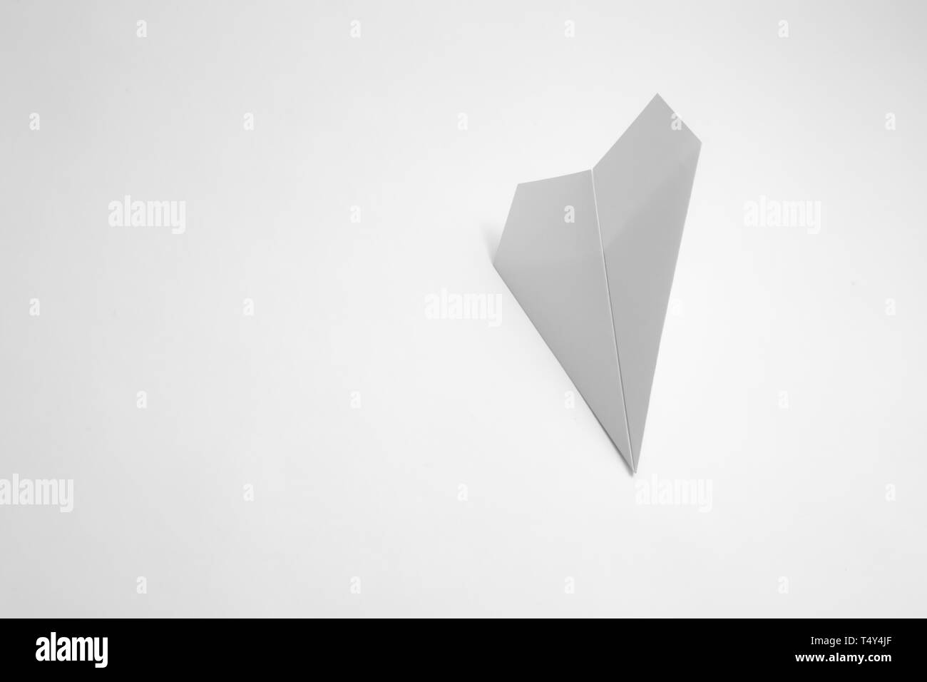 paper airplane on pastel background. Minimal flat lay school concept