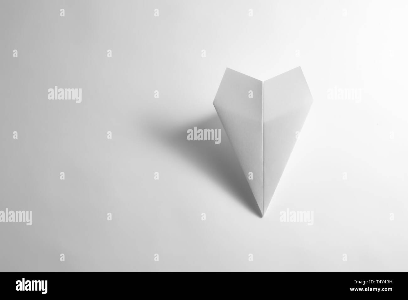 paper airplane on pastel background. Minimal flat lay school concept