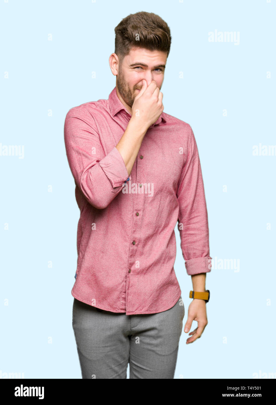 Young handsome business casual man smelling something stinky and  disgusting, intolerable smell, holding breath with fingers on nose. Bad  smells concep Stock Photo - Alamy, image size:947x1390